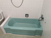 Vintage seafoam green tub, sink, and vanity