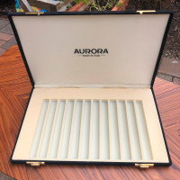 Writing instrument pen holders with Aurora , Sailor logo.