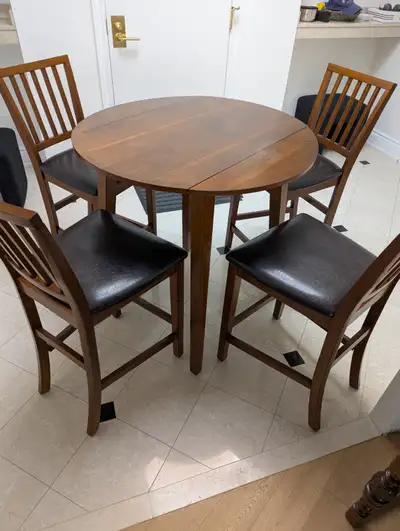 Solid-wood counter-height dining table with 4 matching chairs., View more