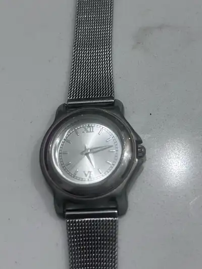 This is an ESP watch with a silver band and dial. It is in fair, used condition. Watch doesn’t work....