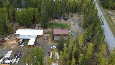 Escape to 5 acres just minutes from downtown Cranbrook - where home meets business. This cedar sided...