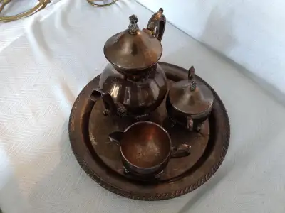 Silver plated tea service in very bad need of cleaning. (Very tarnished) The tray has a lot of scrat...