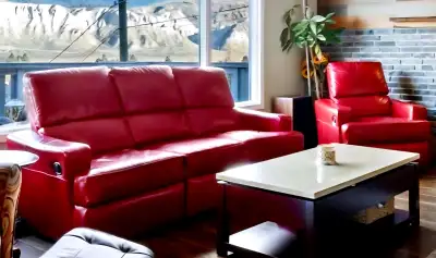 Red leather reclining sofa with matching recliner. Chair Sofa both chairs recline Some faint marking...