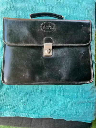 Black leather Bugatti briefcase with multiple compartments, View more