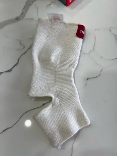 This is a Tensor brand ankle brace in a size medium. The brace is designed to provide support and co...