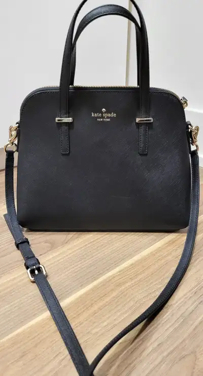 Selling my Black Kate Spade Cedar Street Maise Crossbody Bag. Has four purse feet that protect the b...