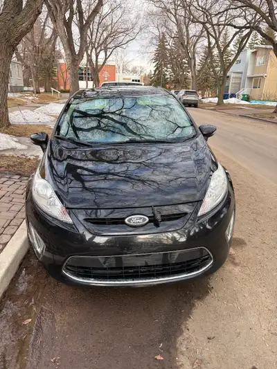 Selling my 2011 Ford Fiesta hatchback. Great on gas and perfect daily commuter. Details: * 157,024 k...