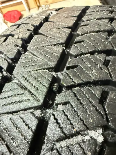 Selling a single Bridgestone winter tire that's in used condition and mounted on a steel rim for a c...