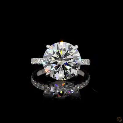 Absolutely stunning 5.00ct Round Brilliant diamond set in solid Platinum with a full pavé band, hidd...