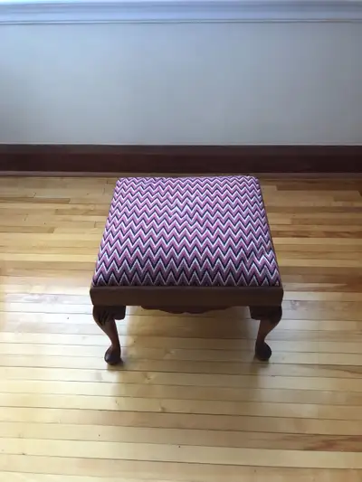 Antique elegantly carved and constructed solid wood footstool with pink, black and white upholstered...