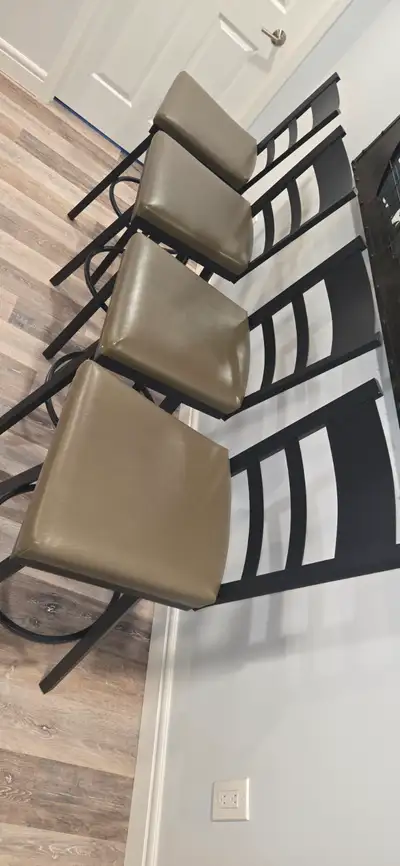 4 medal bar stools with vinyl cushion covers. Great condition but seam is spreading in the corner. M...