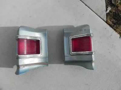 1967 Chevelle Tail Light Extentions with lens and trim good shape NO broken studs and gaskets in goo...