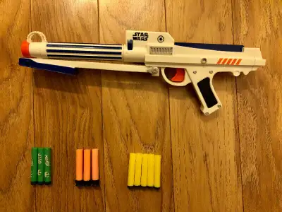 This Star Wars blaster loads from the front. There’s a rectangular bolt action prime on the side. Wh...