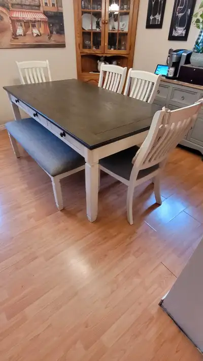 60 x 40 inch table with 4 padded chairs and bench in as new condition.