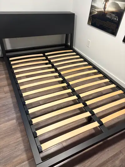 Black metal platform bed from CB2. Contemporary style, black metal. Headboard also can act as a shel...