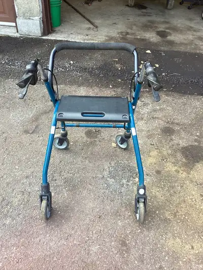 Walker light weight four wheeled with hand brakes collapses for easy storage and has seat can be adj...