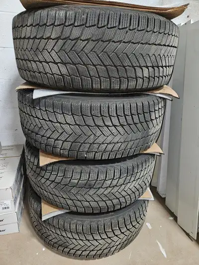 Virtually new 20" Michelin X Ice tires and black gloss rims. 275/50/R20