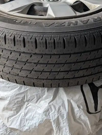 These pre-owned Bridgestone Ecopia EP422 Plus all-season tires, sized 215/65R16, come mounted on ste...