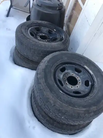 These are a set of used tires with black steel rims, perfect for getting your vehicle back on the ro...