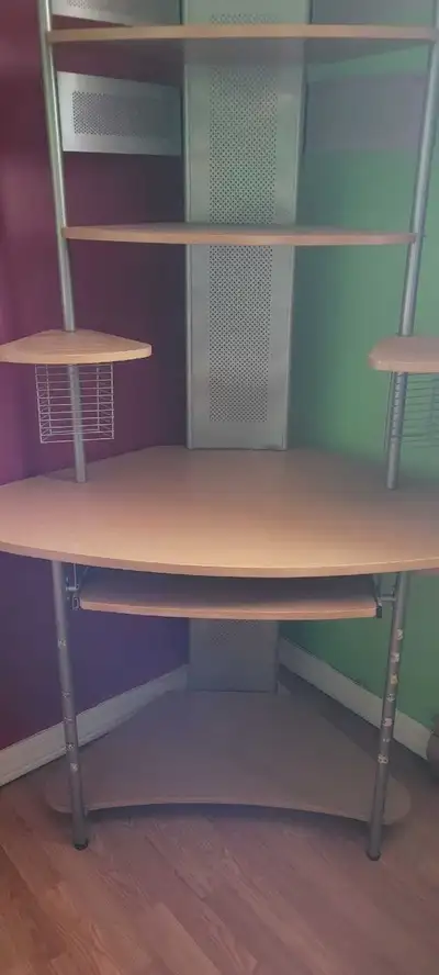 Multi functional computer desk with a slide out piece for the keyboard. Also spots for CD's.... magn...