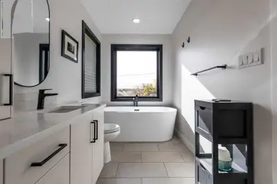 Relax in this upscale furnished master suite featuring a spa-inspired ensuite with soaker tub and wa...