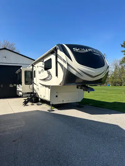 2020 Grand Design Solitude 310GK fifth wheel trailer Large main kitchen and living area with firepla...
