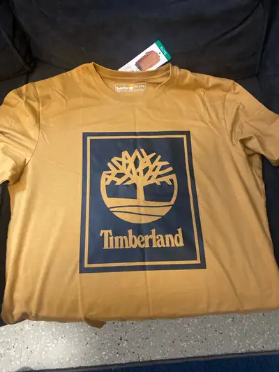 This is a brand new Timberland T-shirt, size XL, in a stylish gold colour, perfect for casual wear....