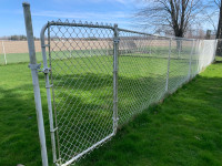 Section of chain link fence with gate. 