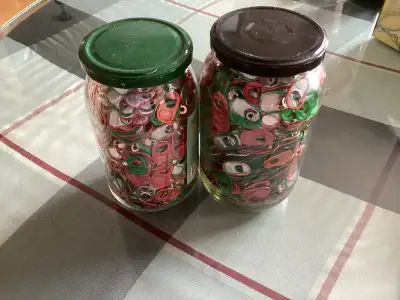 Glass jar of red and green can/pop tabs, View more