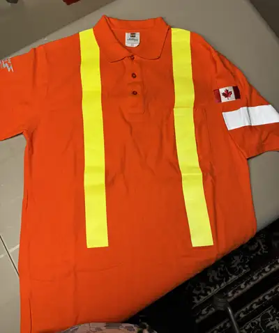 I'm selling a Millworks hi-visibility orange polo shirt, perfect for work or outdoor activities wher...