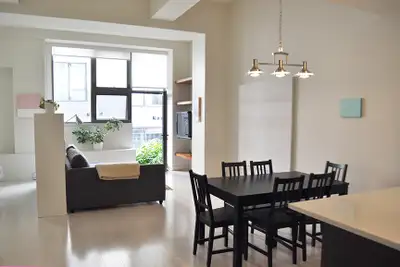 This first-floor, furnished, open-loft condo with 16’ high ceilings and a private patio is situated...