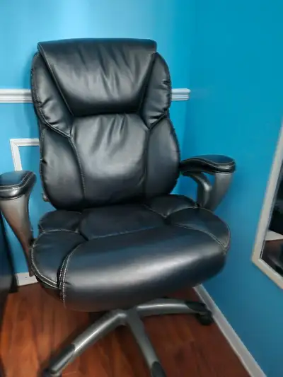 This is a used black executive leather office chair designed for comfort and support during long wor...