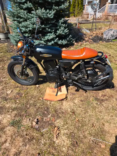 Cafe style E Motorcycle. 750 W . Fast and Fun. Has radio and Bluetooth Modeled after Triumph cafe ra...