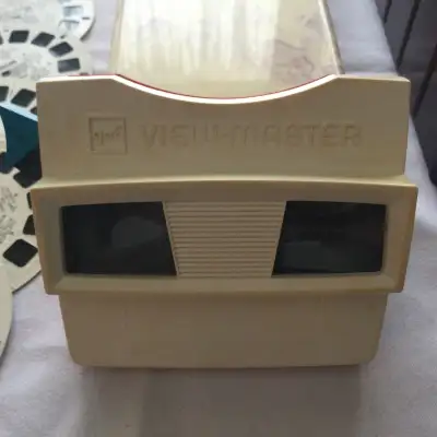 Vintage 70s GAF View-Master reel viewer, red and white color and blue handle. This reel viewer is in...