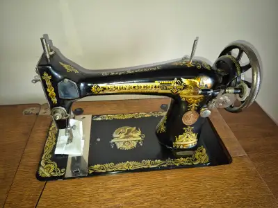 Extremely nice Singer sewing machine and cabinet. $400