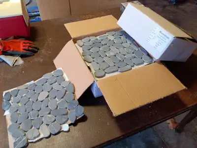 23 sf of Honed Grey Riverstone Tiles, View more