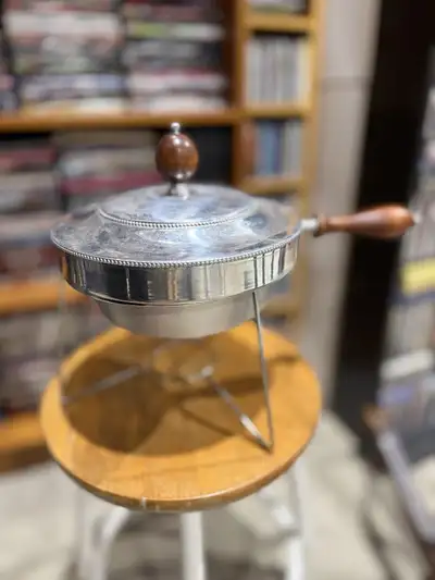 This is a vintage silver chafing dish with a wood handle and a lid. It is in good condition. It woul...