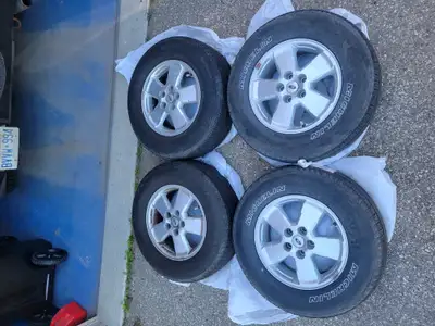 Set of 4 used tires on rims. Stored in bags in a garage since 2020. Lots of tread left.