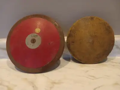 As pictured 2 - VINTAGE DISCUS DISCS 1980S ERA 1 - Wooden 7 inch disc 1 - 8.5 inch 1.61 k weight $20...