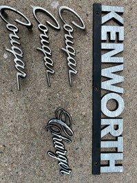 Vintage chrome emblems from Cougar, Charger cars and Kenworth se