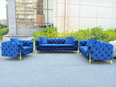 This elegant blue velvet sofa set includes a three-seater sofa and two armchairs, perfect for adding...