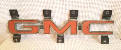 Plastic grille emblem. The red paint could use a touch up but otherwise, its all there, intact, and...