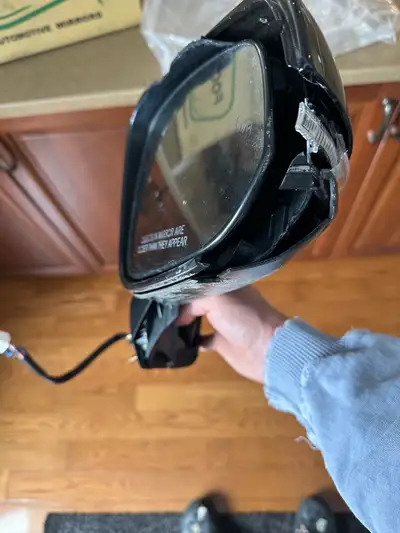 Hit the garage wall backing out and outside housing broke. Still functional, maybe you just need the...