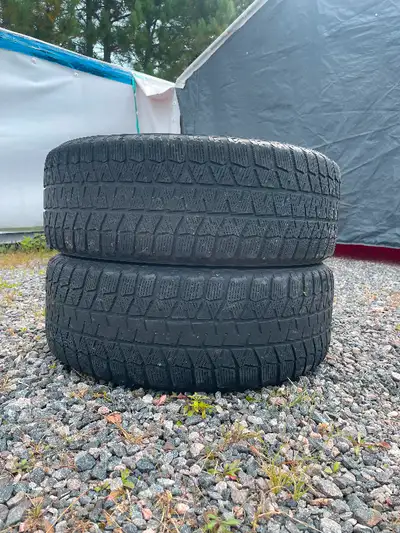 2 Steel Honda rims with Center caps mounted with 215/55r17 Bridgestone blizzack snow tires $125 or b...