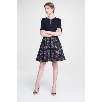 This is a Ted Baker dress in excellent condition, featuring a black bodice and a beautiful floral pr...