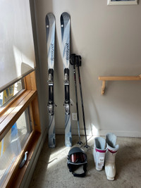 Skis, boots, poles, helmet and goggles