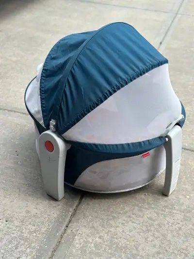 This is a Fisher-Price Portable Bassinet On-The-Go Baby Dome, perfect for travel and playtime, that...