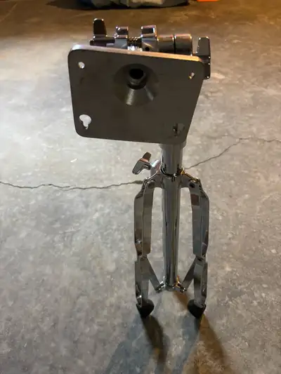 This is a used drum throne base designed to support a drum seat, providing stability for drummers. T...