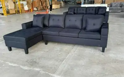 This is a new sofa, perfect for a living room or den, with a chaise lounge on one side, offering amp...