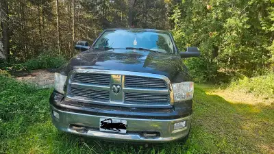 Here is a 2011 Dodge Ram 1500 4WD 5.7 Hemi with an automatic transmission.. It is a full 4 door that...